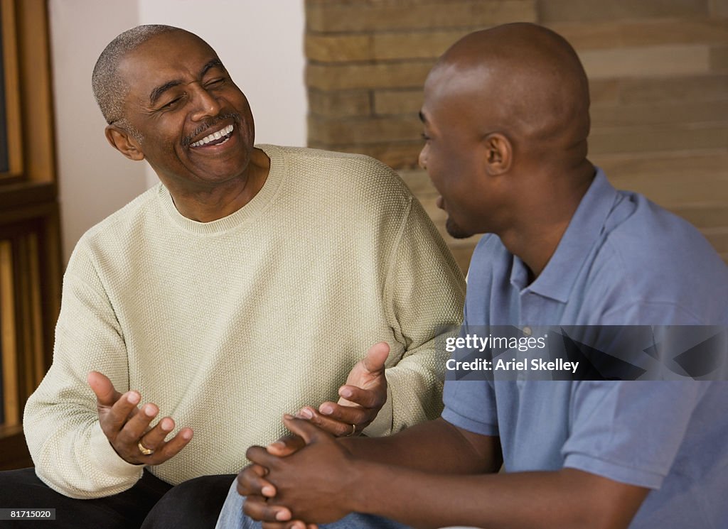 African father and adult son talking