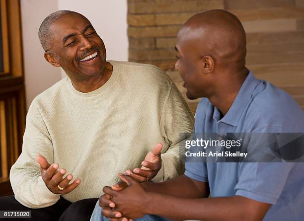 african father and adult son talking - dad advice stock pictures, royalty-free photos & images