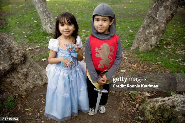 hispanic siblings wearing halloween costume - prinzessin stock-fotos und bilder