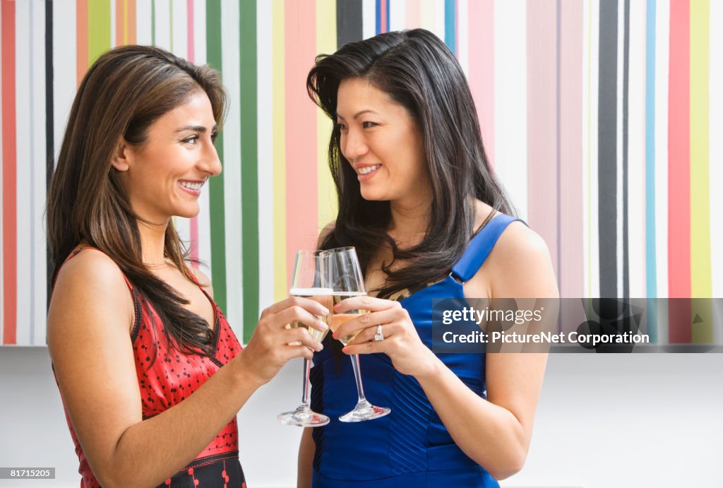 Multi-ethnic women toasting with champagne