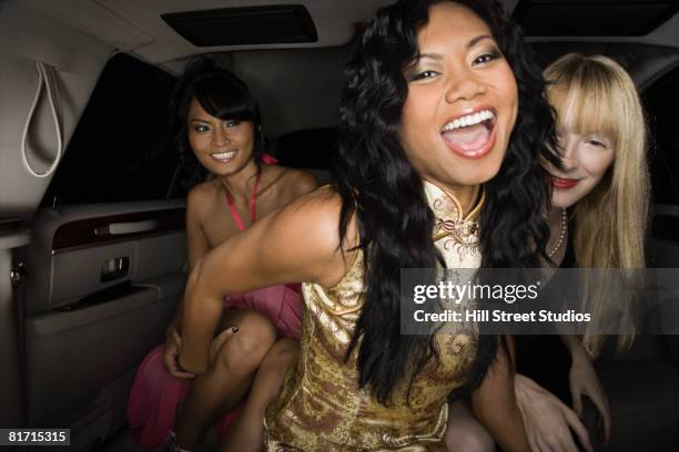 multi-ethnic women laughing in limousine - prom stock pictures, royalty-free photos & images