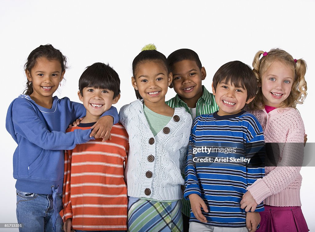 Multi-ethnic children hugging