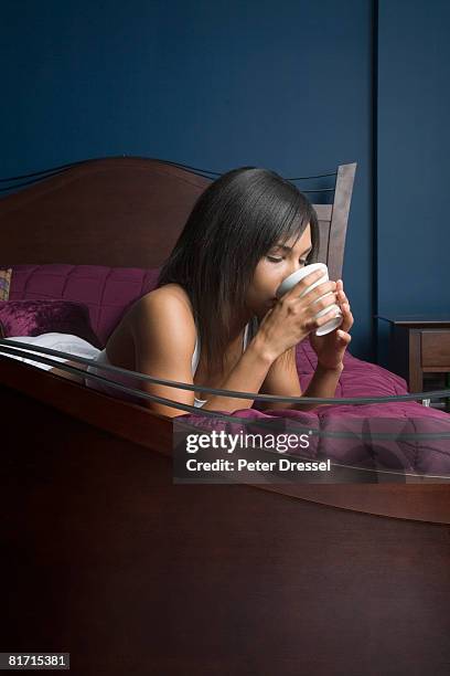 mixed race woman drinking coffee - mixed race woman drinking tea stock-fotos und bilder