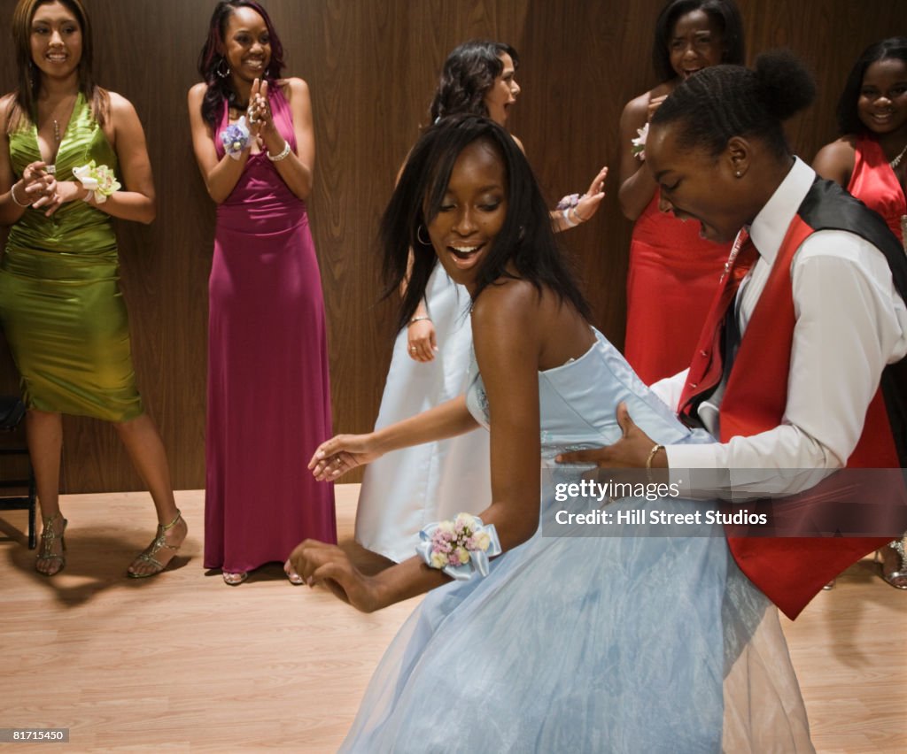 Multi-ethnic teenagers dancing at prom