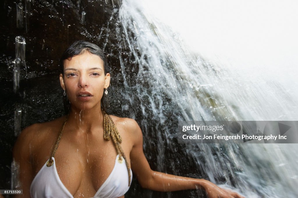 Hispanic woman under waterfall