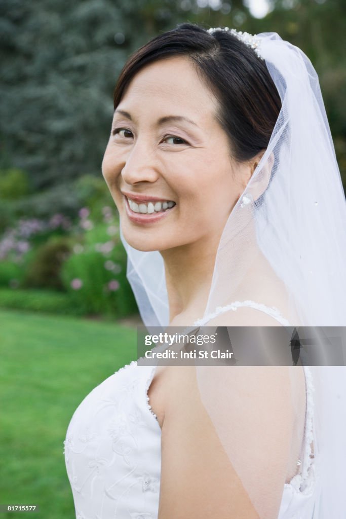 Asian bride looking over shoulder