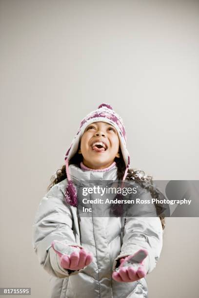 mixed race girl sticking out tongue in snow - fake of indian girls - fotografias e filmes do acervo