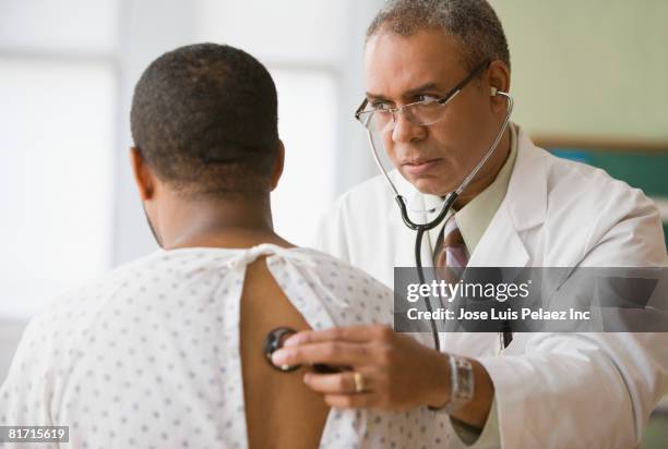 african male doctor examining patient - breathing problems stock pictures, royalty-free photos & images