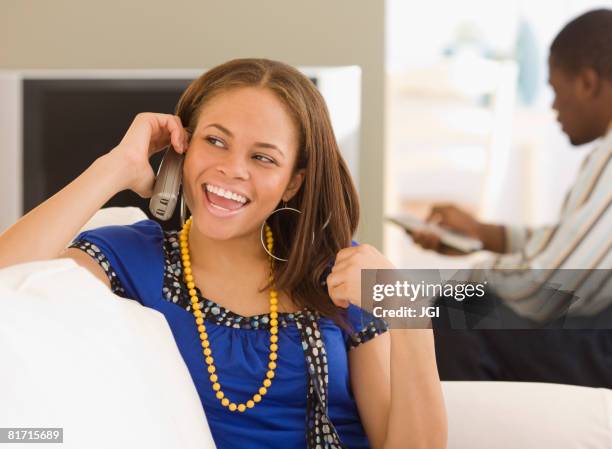 african woman talking on telephone - landline phone home stock pictures, royalty-free photos & images