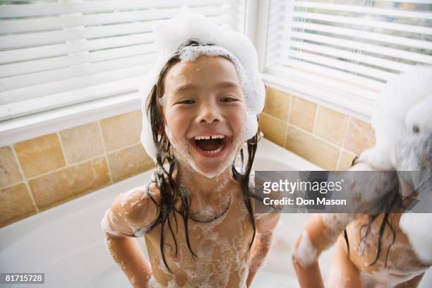 asian sisters in bubble bath - bath girl stockfoto's en -beelden