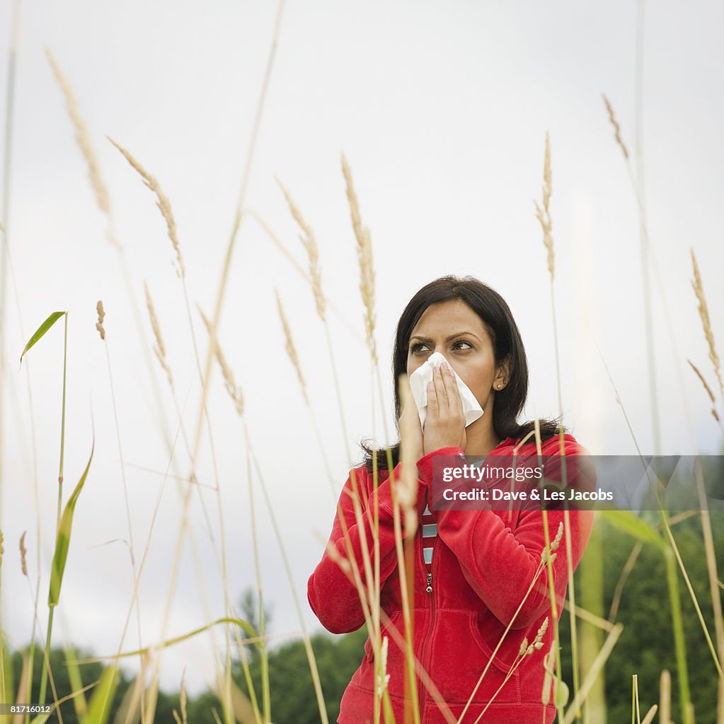 Indian woman blowing nose