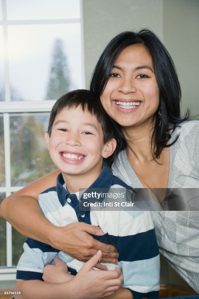 Mixed Race mother and son hugging