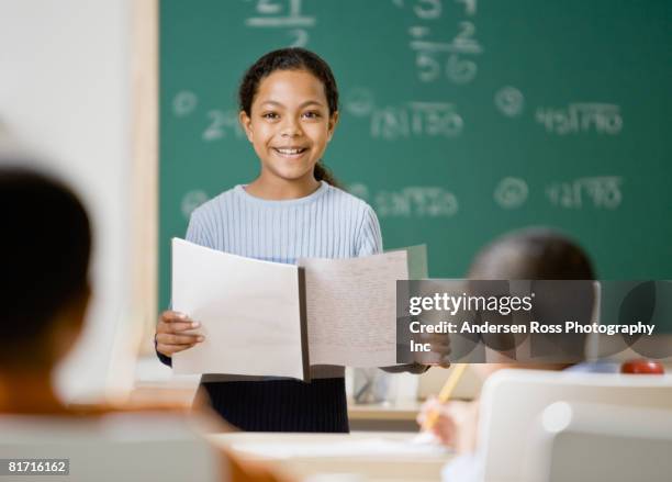 mixed race girl giving presentation in school - arab student kids stock pictures, royalty-free photos & images