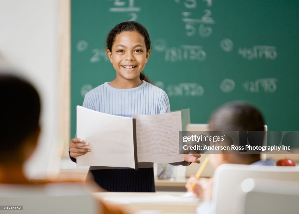 Mixed Race girl giving presentation in school