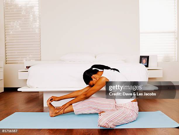 indian woman stretching on yoga mat - exercise routine stock pictures, royalty-free photos & images