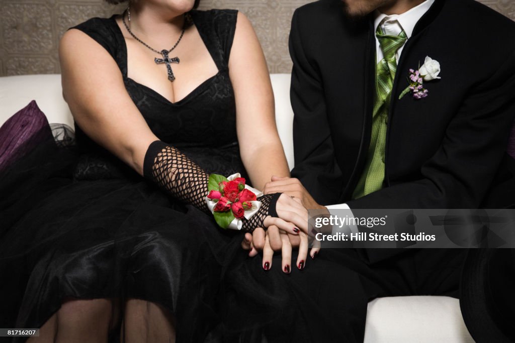 Multi-ethnic teenaged couple holding hands