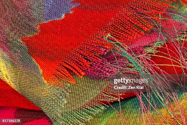 extreme close-up of a multicolored fabric shows unravelling edges - frayed stock pictures, royalty-free photos & images