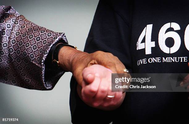 Nelson Mandela grips on to a helper as he leaves the InterContinental Hotel after a photoshoot with celebrity photographer Terry O'Neil on June 26,...