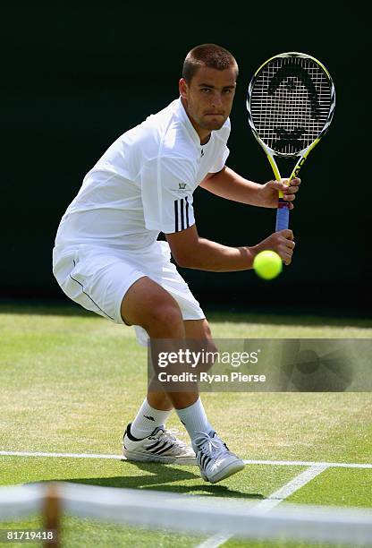 Mikhail Youzhny of Russia plays a backhand during the round two men's singles match against Stefano Galvani of Italy on day four of the Wimbledon...