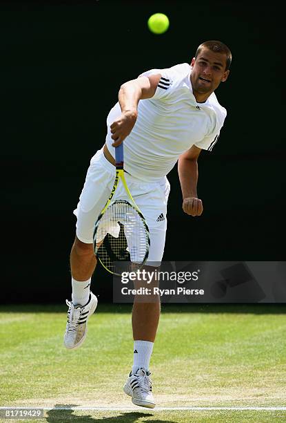 Mikhail Youzhny of Russia serves during the round two men's singles match against Stefano Galvani of Italy on day four of the Wimbledon Lawn Tennis...