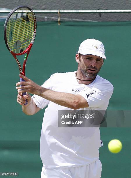 Italy's Stefano Galvani returns the ball to his Russian opponent Mikhail Youzhny during their 2008 Wimbledon championships tennis match at The All...