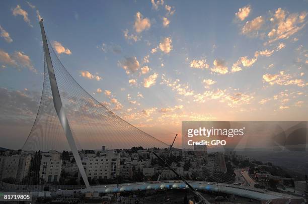 In this handout photo provided by the Israeli Government Press Office , the sun sets behind the Chords Bridge, designed by Spanish architect Santiago...