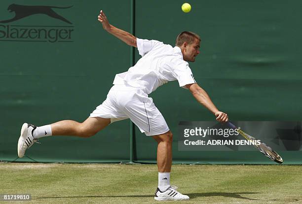 Russia's Mikhail Youzhny returns the ball to his Italian opponent Stefano Galvani during their 2008 Wimbledon championships tennis match at The All...