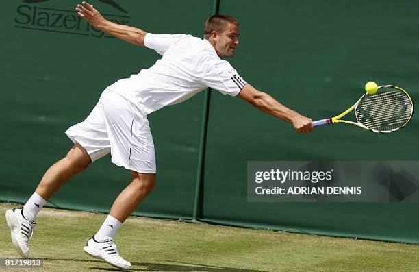 Russia's Mikhail Youzhny returns the ball to his Italian opponent Stefano Galvani during their 2008 Wimbledon championships tennis match at The All...