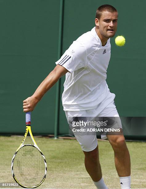 Russia's Mikhail Youzhny returns the ball to his Italian opponent Stefano Galvani during their 2008 Wimbledon championships tennis match at The All...