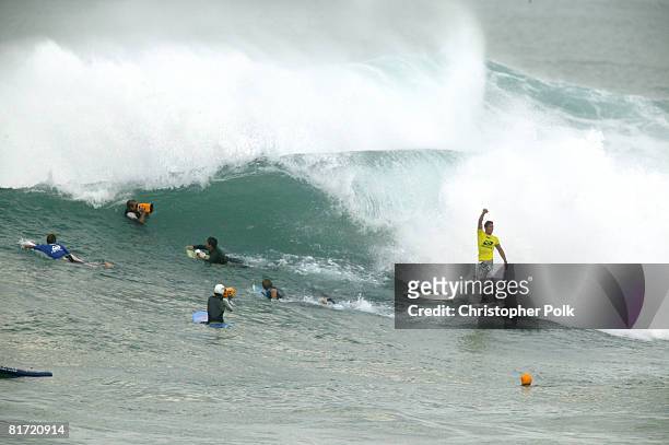 Andy Irons of Hawaii raises his hands after a double barrell in the finals heat of the the Rip Curl Cup 2003 at Sunset Beach on the North Shore of...
