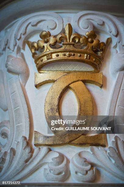 This photograph taken on July 17 shows the monogram of Catherine de Medicis inside Chateau Chenonceau on the River Cher, some 30kms east of Tours. -...