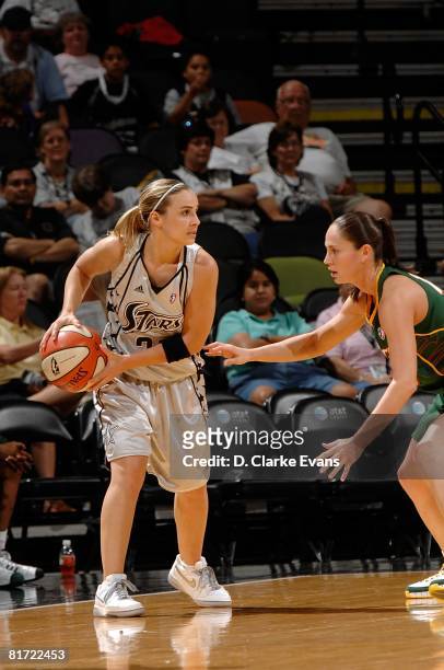 Becky Hammon of the San Antonio Silver Stars looks to pass the ball against Sue Bird of the Seattle Storm during the WNBA game on June 13, 2008 at...