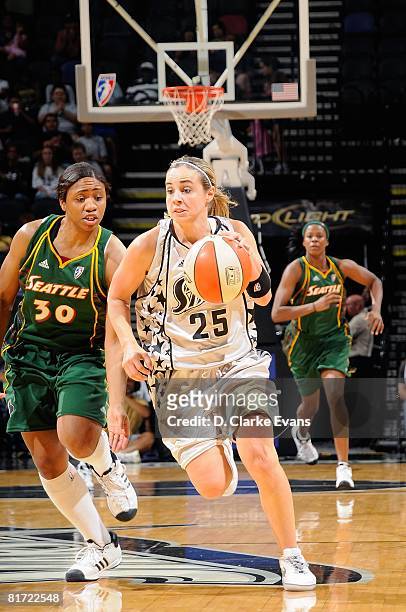 Becky Hammon of the San Antonio Silver Stars drives down the court against Tanisha Wright of the Seattle Storm during the WNBA game on June 13, 2008...