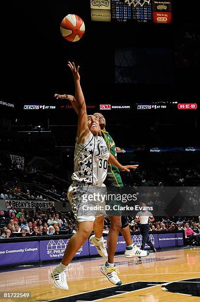 Helen Darling of the San Antonio Silver Stars puts up a shot under pressure against Swin Cash of the Seattle Storm during the WNBA game on June 13,...
