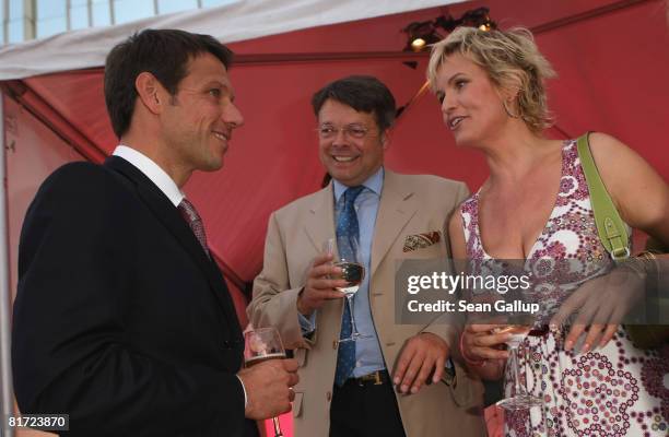 Deutsche Telekom head Rene Obermann, Peter Schwenkow and television presenter Carola Ferstl attend the Bild Summer Party on June 26, 2008 in Berlin,...