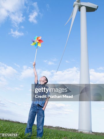 Windmill Boy Young Boy Outdoors Holding A Toy Windmill By A Real Windmill High-Res ...