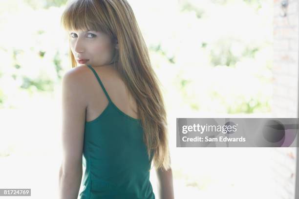 woman outdoors on patio looking at camera - tank top back stock pictures, royalty-free photos & images