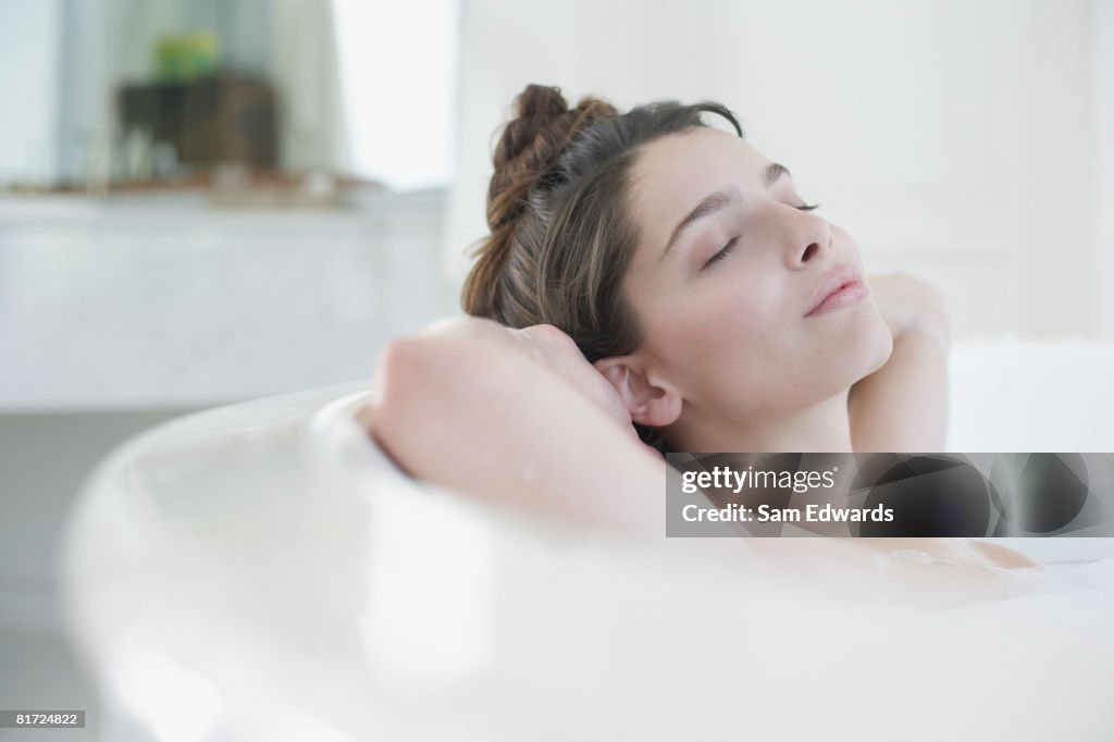 Woman relaxing in bubble bath