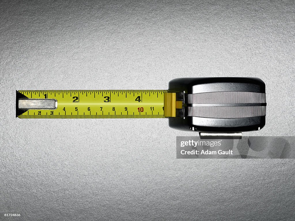 A measuring tape with five inches showing