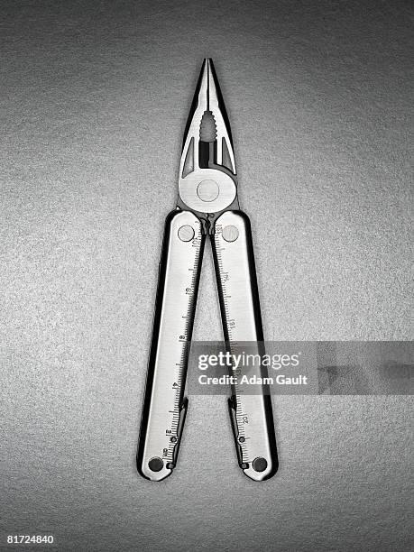 a pair of multifunctional silver pliers - multipurpose tool stock-fotos und bilder