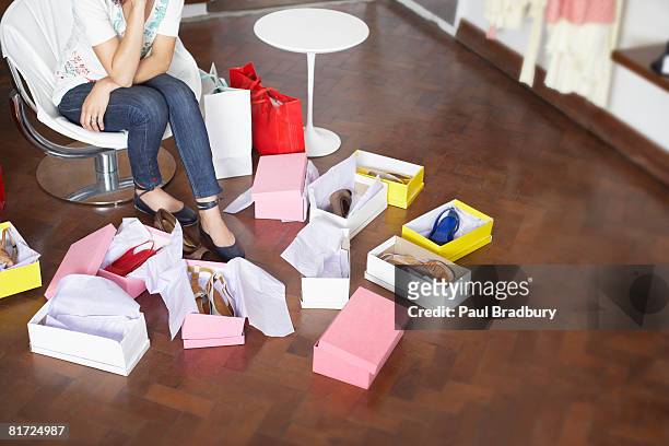 woman in department store trying on shoes - shoe boxes stock pictures, royalty-free photos & images