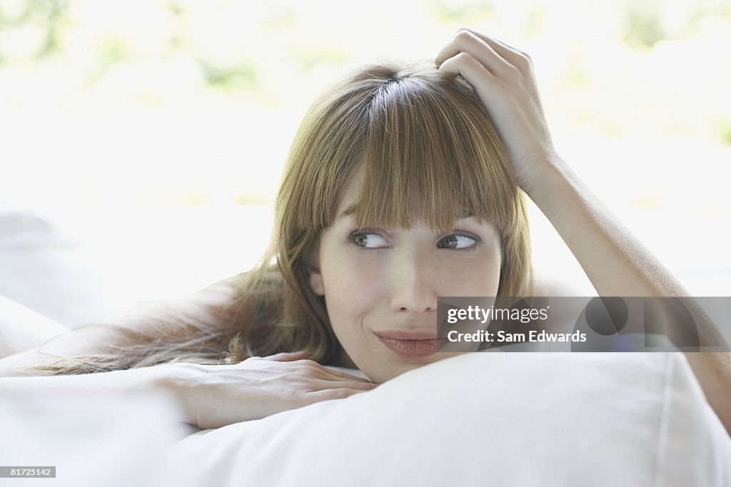 Woman outdoors relaxing on patio lounger