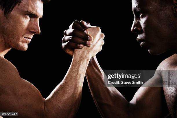 two men arm wrestling - arm wrestle stock pictures, royalty-free photos & images