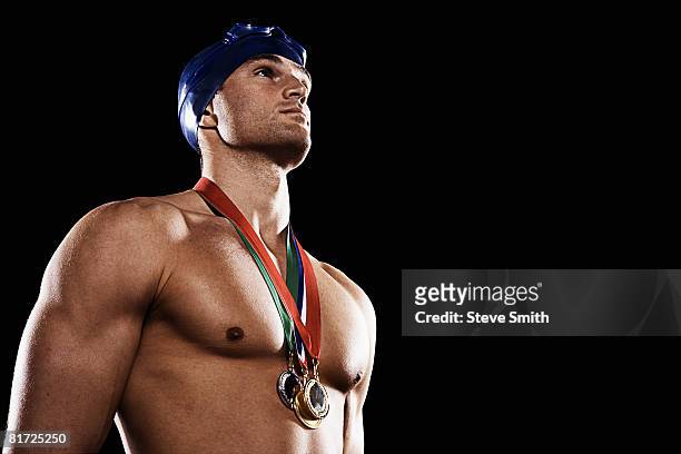 swimmer with three medals wearing cap and goggles - sportsperson medal stock pictures, royalty-free photos & images