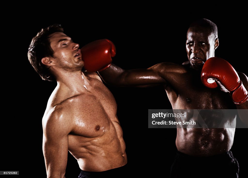 Two men boxing with one being hit