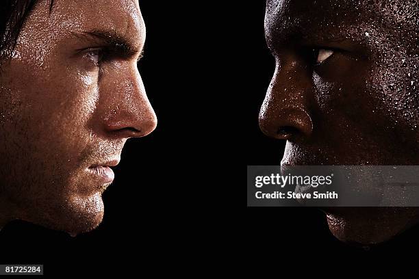 two sweaty men looking at each other in intimidation - confrontation stock-fotos und bilder