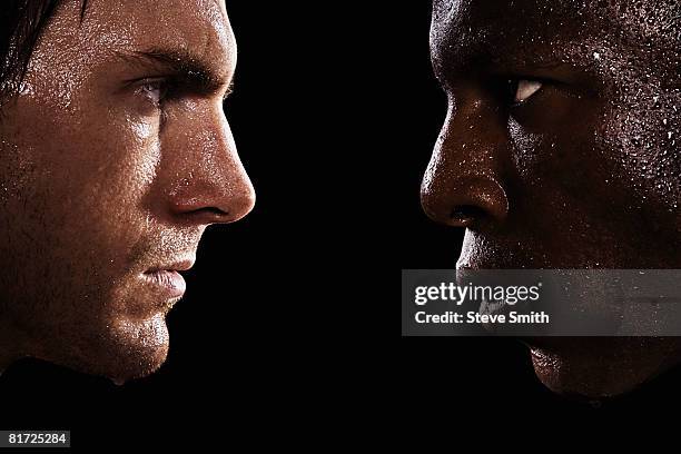 two sweaty men looking at each other in intimidation - confrontación fotografías e imágenes de stock