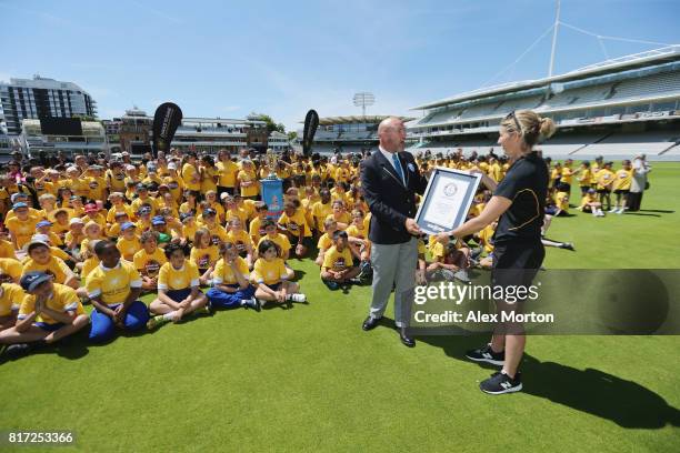 Official Guinness World Record adjudicator Glenn Pollard presents former England captain Charlotte Edwards with a certificate confirming the...