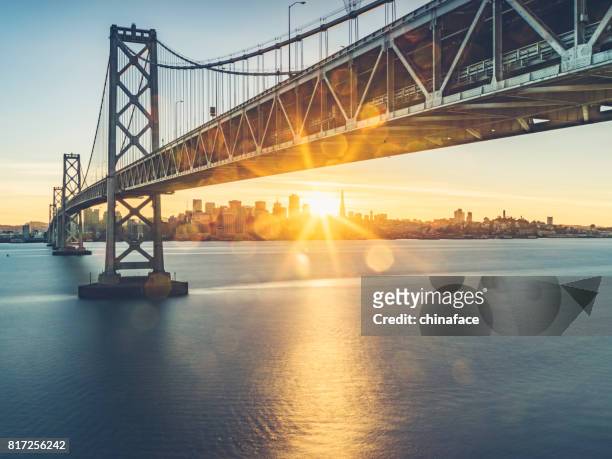 view of bay bridge and san francsico city skyline from yerba buena island - bridge stock pictures, royalty-free photos & images