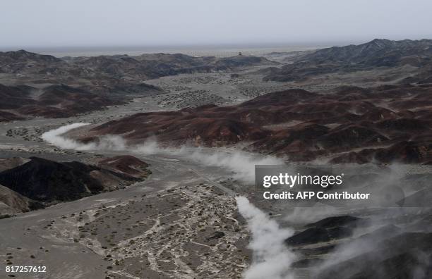 Peugeot's French driver Cyril Despres and co-driver David Castera of France compete during the Stage 10 of the Silk Way 2017 between Hami and...